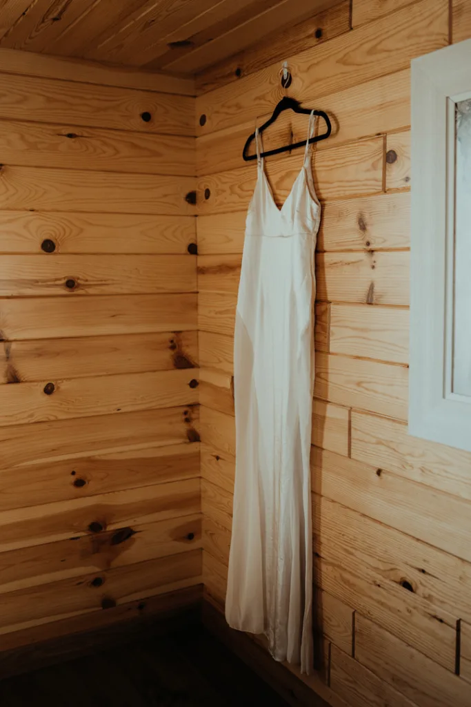 Wedding dress hanging in a cabin